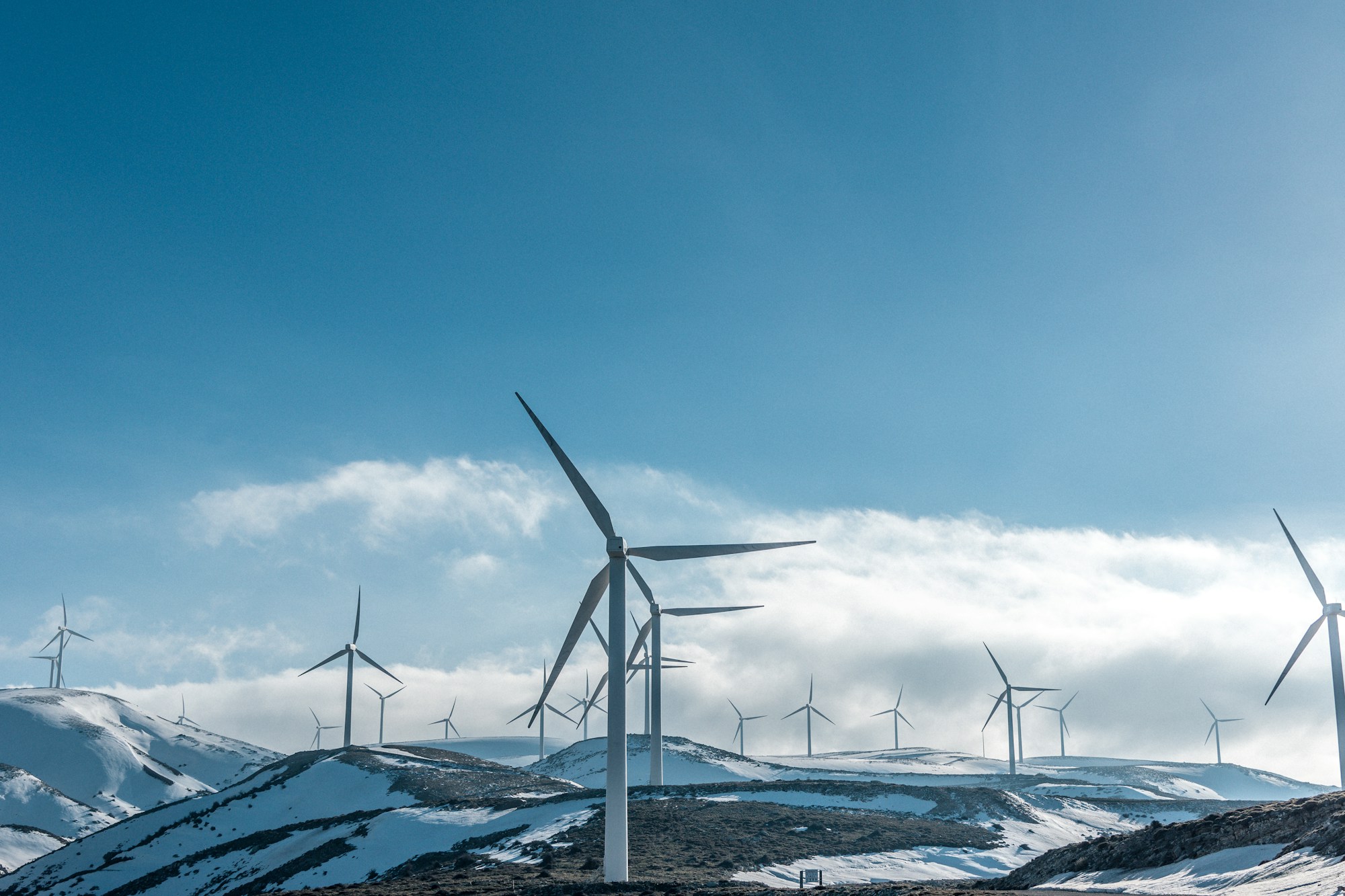 Wind turbines on a mountain slope under a clear sky